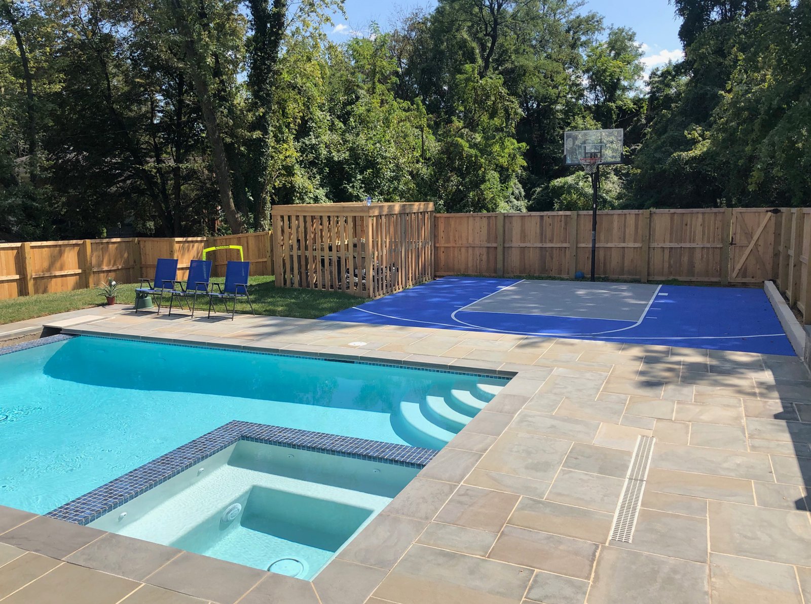 A finished poolside backyard sport court built from Outdoor Sport Courts interlocking tiles