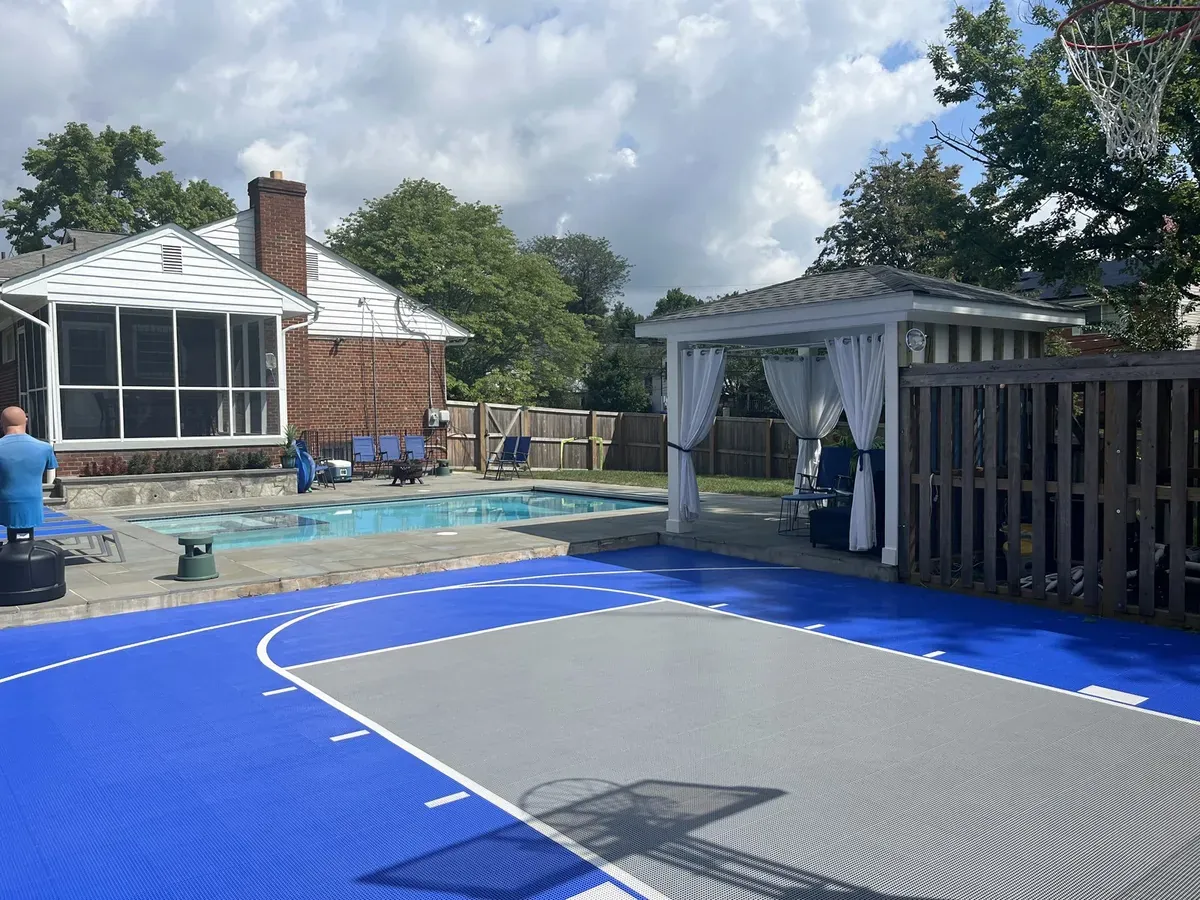 Outdoor tile court beside a pool
